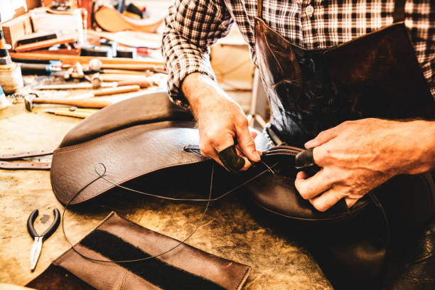 istock A saddle maker making a custom made saddle.  Real person, real life. 1060657758