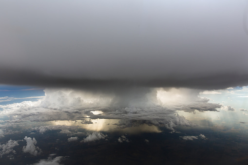 Aerial of of a large thunderstorm. Rain is visible falling from the base of the clouds