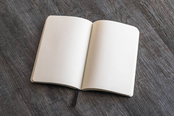 istock Blank open A4 size book, catalog, magazine, brochure, or booklet mock up template paper texture on brown wood table floor 1060666824