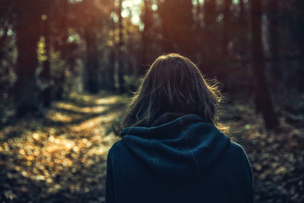 istock woman walking in the field 1060669028