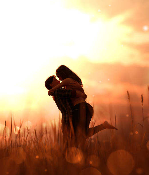Romantic couple in grass field stock photo