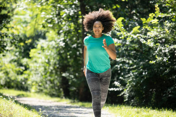 istock African sportswoman jogging outdoors in park 1060675434