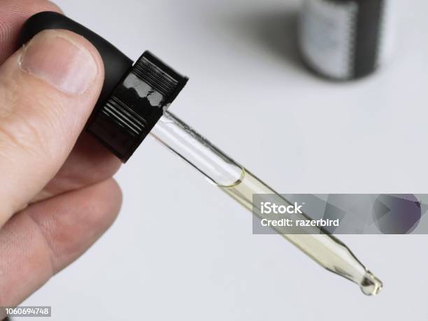 Cbd Cannabis Oil In Dropper Closeup Stock Photo - Download Image Now - Essential Oil, Addict, Addiction