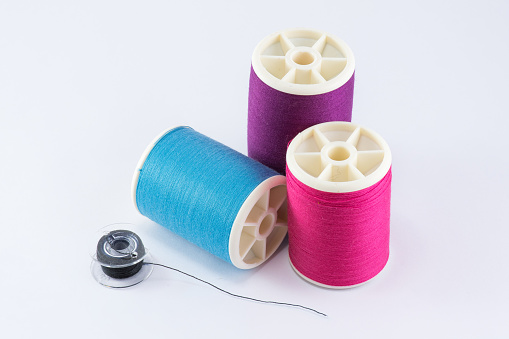 Colorful sewing thread spool isolated on white background.