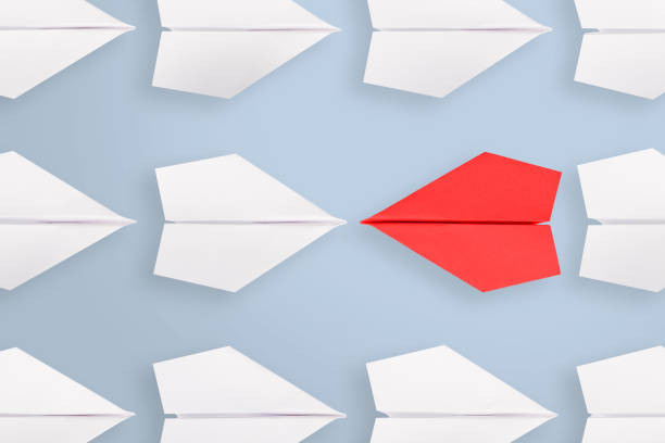 istock Change concepts with red paper airplane leading among white 1060711064