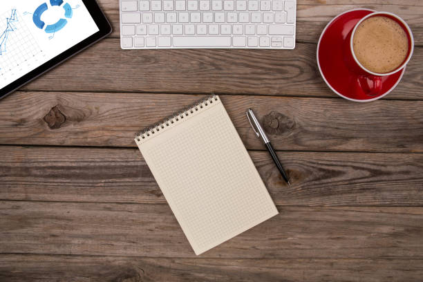 New year resolutions theme: Top view of Notepad, smartphone, digital tablet and sticky notes on a table with copy space