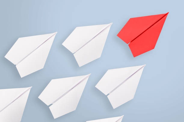 istock Leadership concepts with red paper airplane leading among white 1060712216