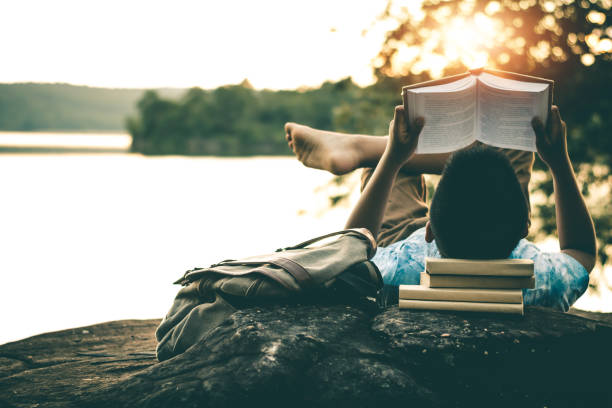 istock Men read books in quiet nature, concept read a books. 1060725446