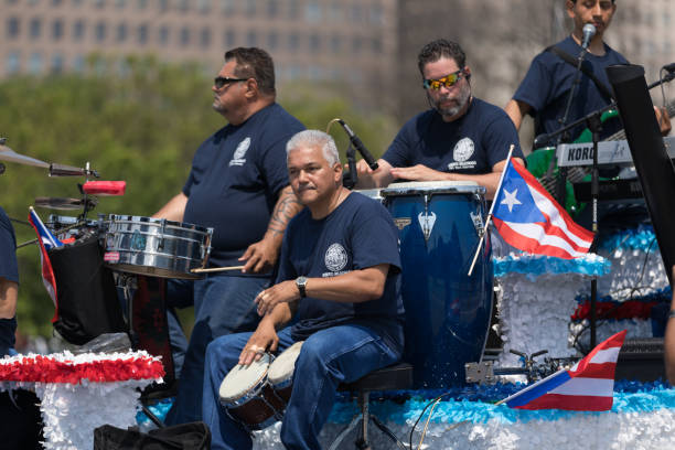 The Puerto Rican Day Parade Chicago, Illinois, USA - June 16, 2018: The Puerto Rican Day Parade, Men playing traditional Puerto Rican music on a float at the parade puerto rican culture stock pictures, royalty-free photos & images