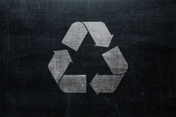 istock Recycle sign on chalkboard isolated on blackboard texture with chalk rubbed background from top view. Recycling infographic element 1060735974