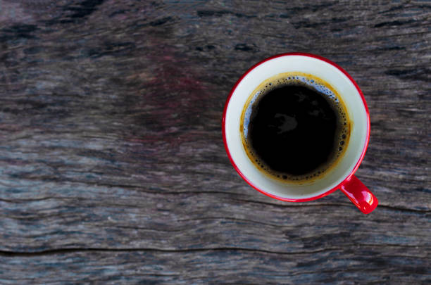 istock Black coffee hot drinks Red cups on wood table backgrounds above 1060739612