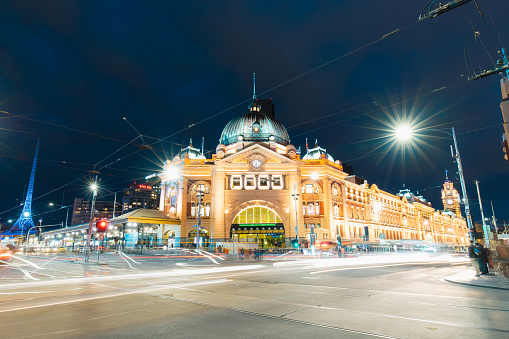 Melbourne, Australia - September 24, 2018: Flinders Station at night with traffic in front of it.