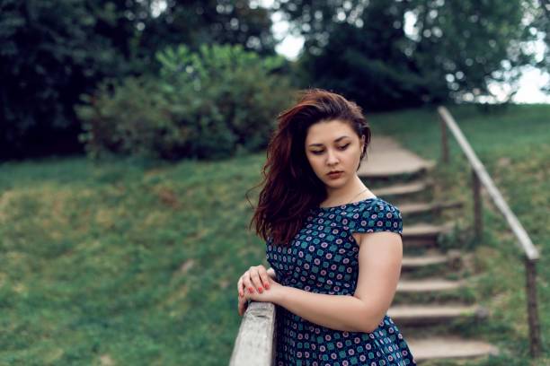 Plump girl on a botanical spring walk