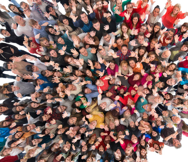 istock Directly above view of crowd with raised arms looking at camera. 1060760826