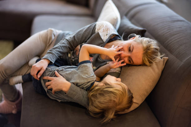 istock Loving mother and son communicating while relaxing on the sofa. 1060761258