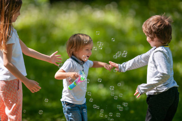 istock Small children playing with bubbles and having fun in the park. 1060764862
