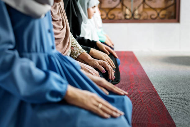 Muslim women meditating in the mosque during Ramadan stock photo