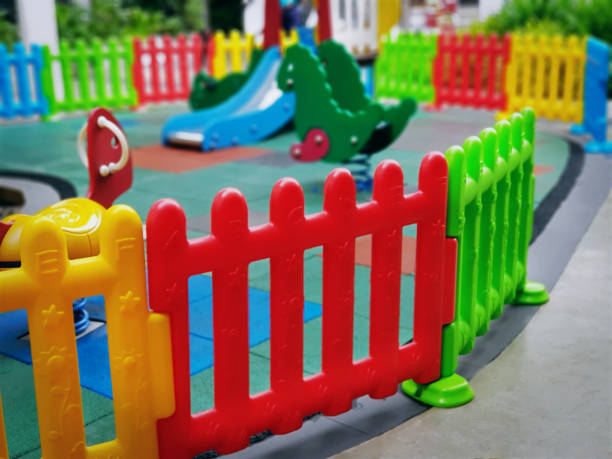 istock Close-up Colorful Plastic Fence Around Kid's Playground with Selective Focus 1060771738