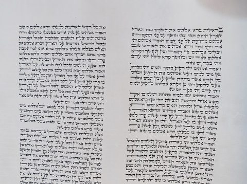A bar mitzvah boy reads a Torah scroll