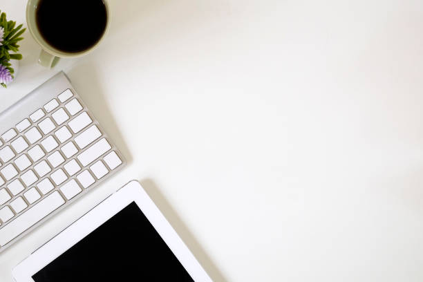 istock Workspace top view desk work with tablet computer and keyboard, cup of coffee with copy space. 1060773514