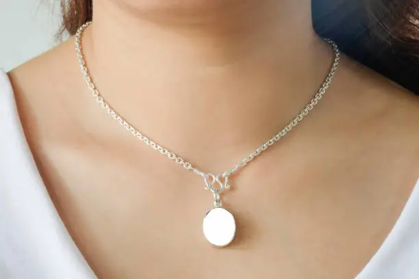 Photo of Woman wearing a mockup montage necklace with empty for add your advertising.
