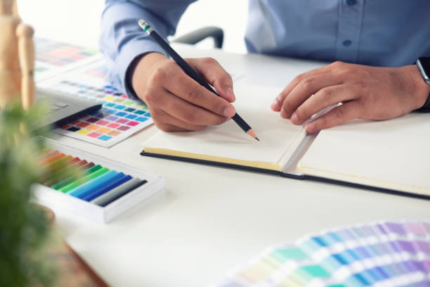 istock Closeup creative working with pencil and sketch book on stylish creative workspace. 1060777290