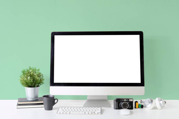 istock Workspace Mockup Computer on white table and object office supplies and green wall. 1060778938