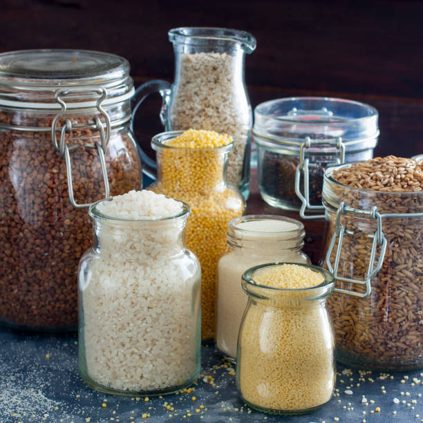 istock Grocery - various cereals in glass jars (rice, millet, oatmeal, couscous, buckwheat, semolina), square image 1060779484