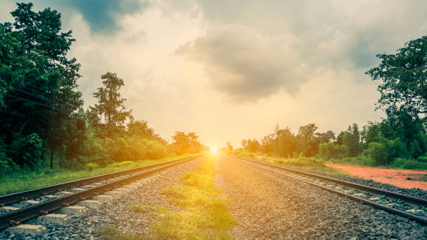 istock Railway tracks in a rural scene with sunset 1060779758