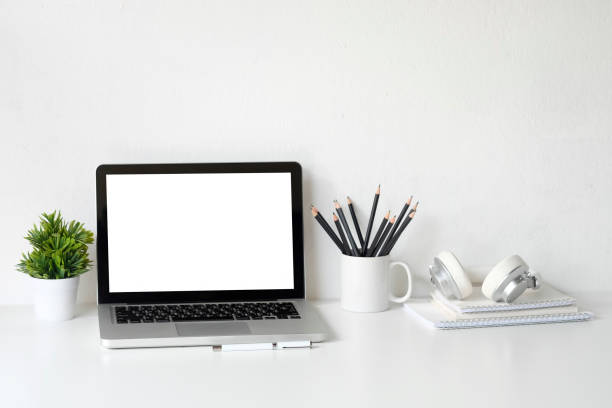 istock Office workspace mockup laptop, tablet, pencil and headphones on office desk. 1060779788
