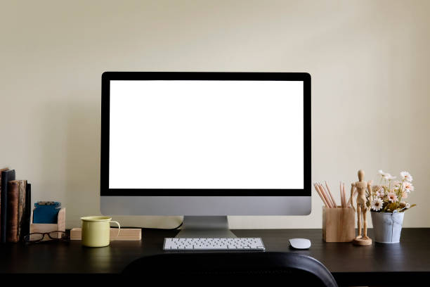 istock Workspace mockup Computer with coffee mug, books, pencil and flower on black table. 1060784132