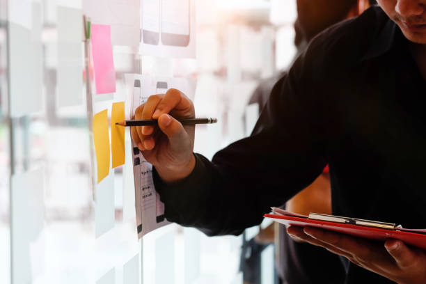 istock A man working with creative and using stocky note paper on glass wall. 1060784558