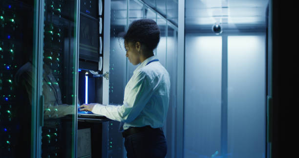 istock Woman diagnosing server hardware in center 1060784744