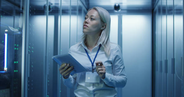 istock Female technician works on a tablet in a data center 1060784746