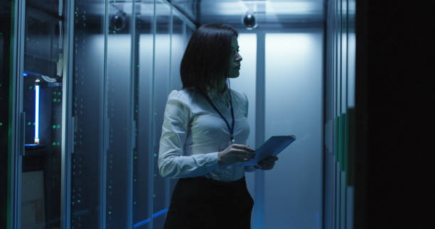 istock Female technician works on a tablet in a data center 1060784748
