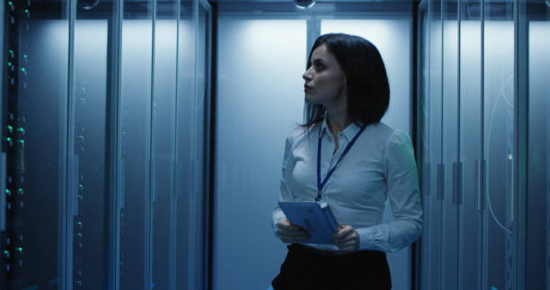 istock Female technician works on a tablet in a data center 1060784750