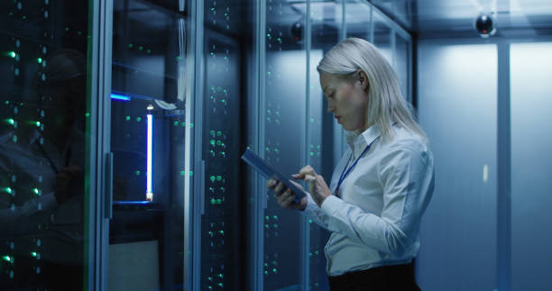 istock Female technician works on a tablet in a data center 1060784968