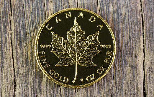 Gold Maple coin on wood