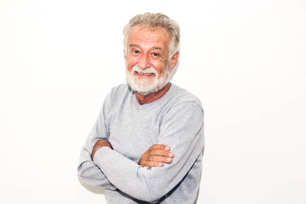 istock Portrait of happy smiling senior man looking at camera while standing on white background 1060787564