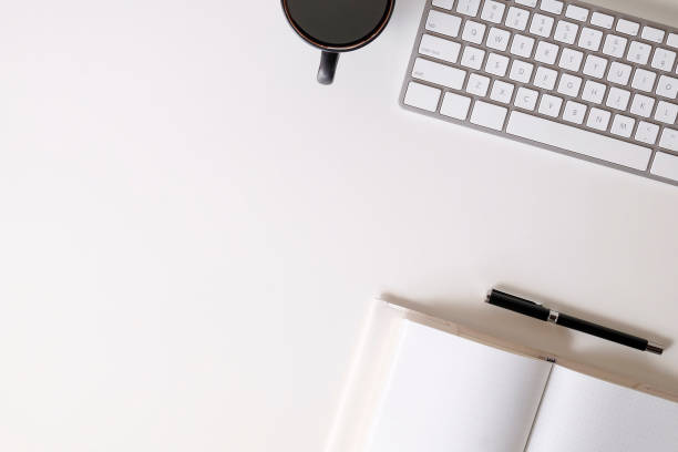 istock Top view office desk computer keyboard, notebook paper and pen with coffee. 1060788992