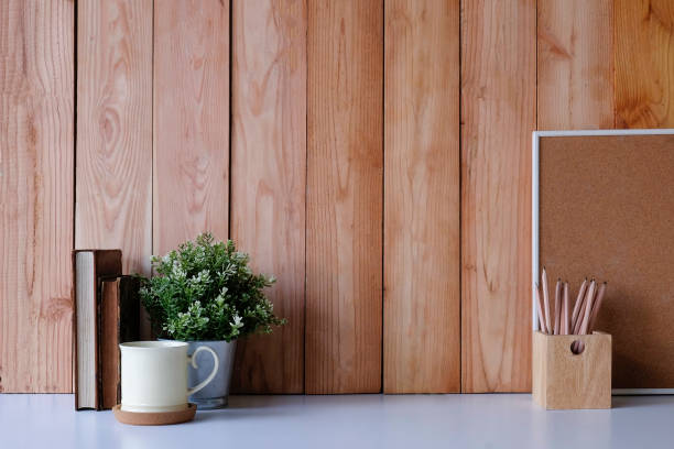 istock Workspace office desk books, coffee mug and plant decoration with pencil on white table and wood wall. 1060790776