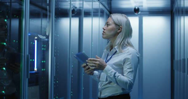 istock Female technician works on a tablet in a data center 1060790836
