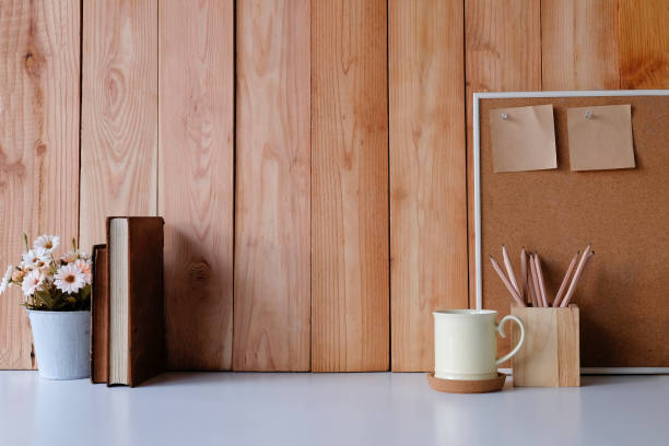 istock Workspace with copy space coffee mug, flower, wood board and sticky note with pencil on office desk. 1060791316
