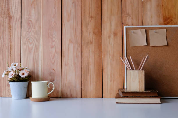 istock Workspace with copy space coffee mug, flower, wood board and sticky note with pencil on office desk. 1060791392