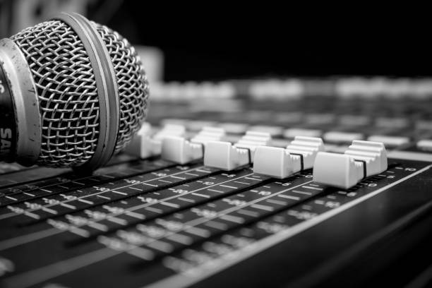 istock Mixing console faders and audio microphone 1060791424