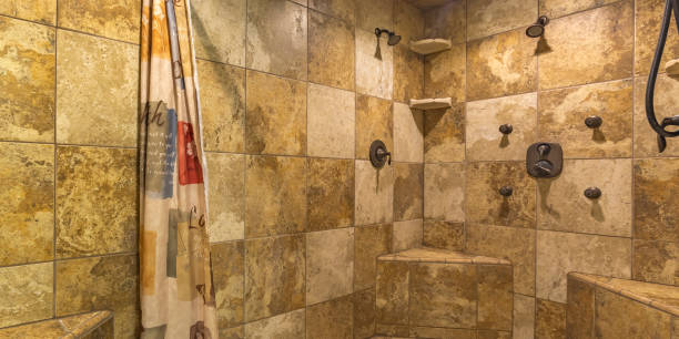 istock Walk in shower with brown tile wall and curtain 1060793916