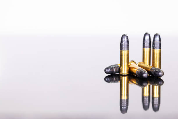 istock group of ammunition on a table with reflections, white background 1060798620