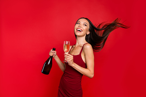 Portrait of alluring beautiful careless carefree brunette with beverage in her hand she stand half turn isolated on red bright background look back make beaming white smile