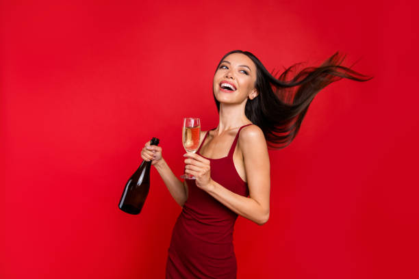 portrait of alluring beautiful careless carefree brunette with beverage in her hand she stand half turn isolated on red bright background look back make beaming white smile - half smile imagens e fotografias de stock