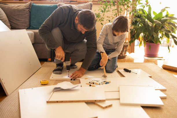 istock Father and son assembling bookshelves at their home 1060805924